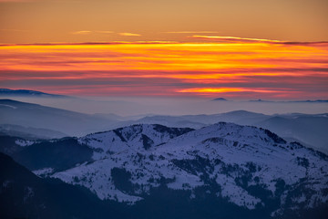 Fototapeta na wymiar Aerial Landscape view from Ceahlău Mountains National Park at sunset in winter season,Sunset in Ceahlau Mountains