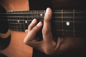 Close up of man hand playing acoustic guitar.