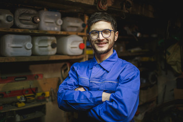 Portrait of a smiling man in his workshop.