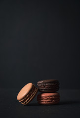 Colourful macaroons on a black colour background,Food concept background Top view Design 