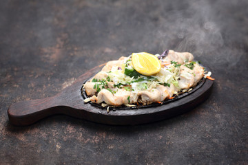 Chicken malai tikka on a hot dish