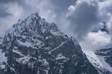 Alpine snow peak against a gloomy sky