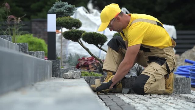 Path Brick Paving Closeup with Some Workers in the Background.