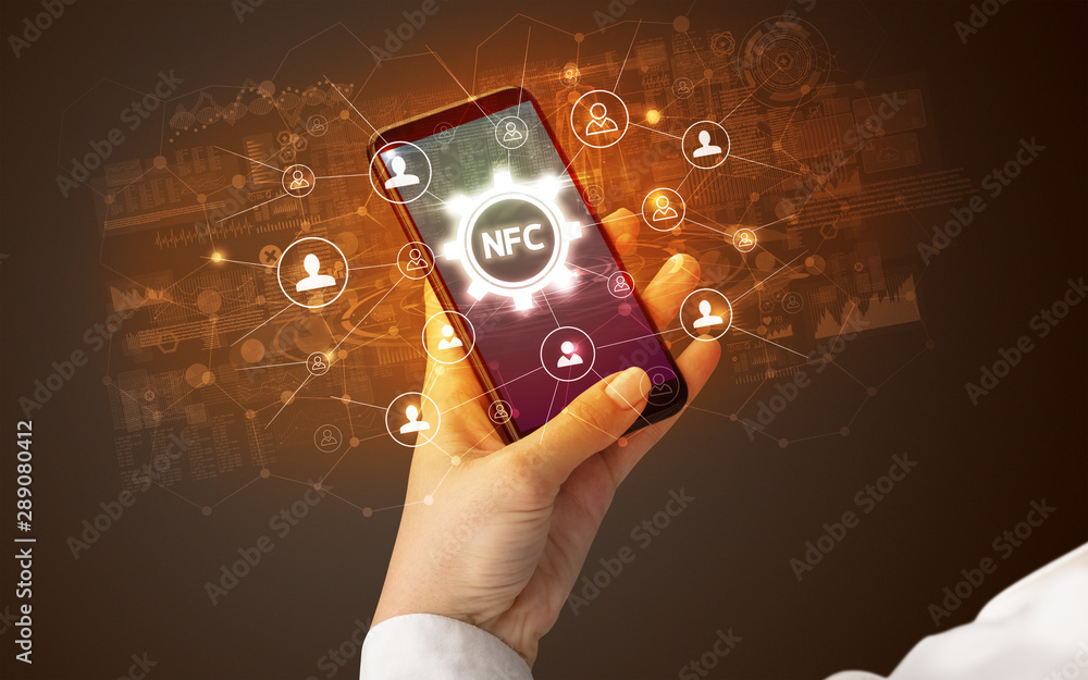 Canvas Prints Female hand holding smartphone with NFC abbreviation, modern technology concept