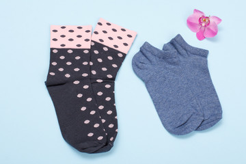 Two pair of women socks on blue background.