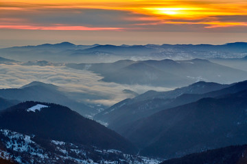 Fototapeta na wymiar Amazing sunrise view from Ceahlău Mountains National in winter season, Winter Landscape in National Park Ceahlau