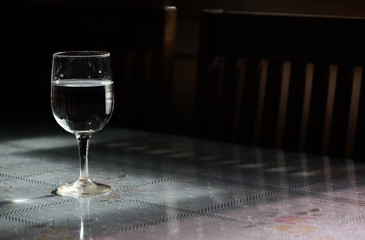 Drinking water and ice in wine glass on dining  table