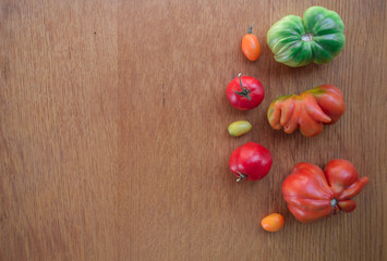 Tomatoes on a wooden background. Top view. Free space for text.