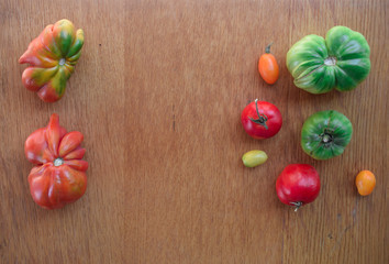 Tomatoes on a wooden background. Top view. Free space for text.
