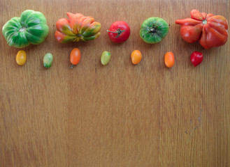 Tomatoes on a wooden background. Top view. Free space for text.