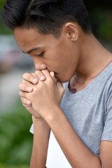 Fototapeta premium A Male Youngster Praying
