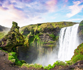 Magical landscape with silhouette of human head in front of waterfall Skogafoss in Iceland. Exotic countries. Amazing places. Popular tourist atraction.