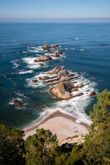 Aerial view over the cliffs of Beach Playa de La Gueirúa on a sunny day, Cudillero Asturias Spain