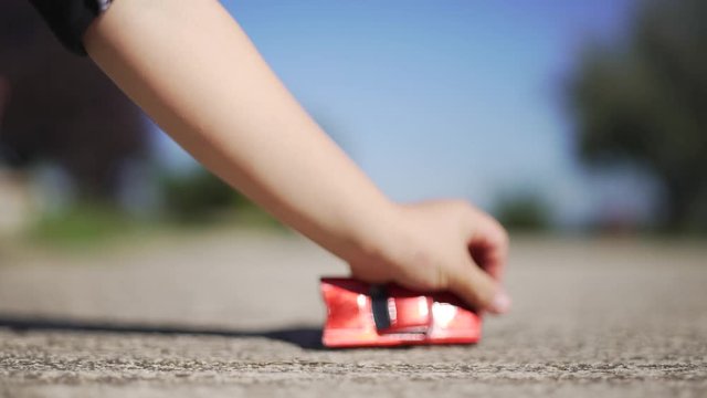 Kid playing with a red toy car on the road. Car crash. Insurance. 