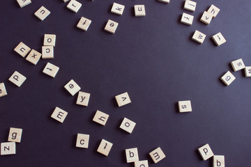 Random wooden letters on black background