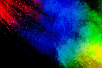 Freeze motion of colorful dust particles on black background.Abstract pastel color powder overlay texture.