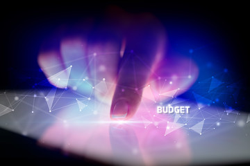 Finger touching tablet with BUDGET inscription, business concept