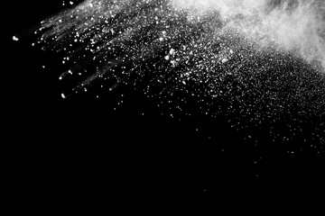 Fototapeta na wymiar White powder explosion isolated on black background. White dust particles splash.