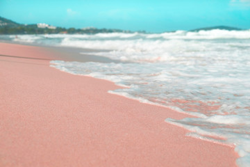 Pink and blue colours, waves on the sand beach