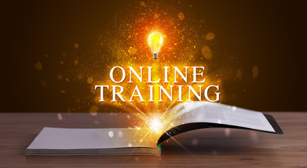 ONLINE TRAINING inscription coming out from an open book, educational concept
