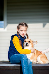 Girl sitting with a Corgi dog © Kiryakova Anna