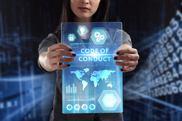The concept of business, technology, the Internet and the network. A young entrepreneur working on a virtual screen of the future and sees the inscription: Code of conduct