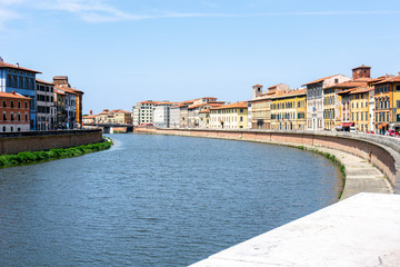 Obraz premium View of the Arno river and colorful, beautiful buildings in Pisa,Tuscany, Italy