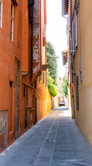 Naklejka na ściany i meble Beauty and narrow street with colorful houses in Pisa,Tuscany, Italy