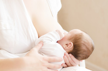 Obraz na płótnie Canvas Young mom breastfeeding her little baby boy.