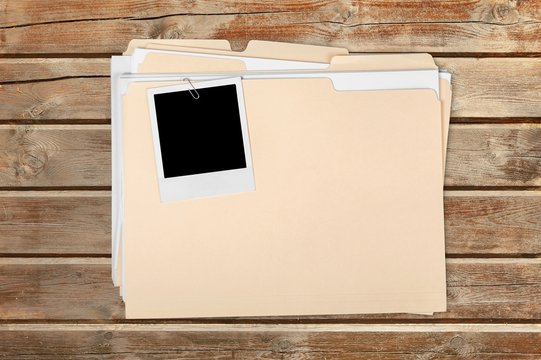 Blank photo on business folder on wooden table