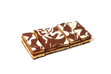 Milk and chocolate slices of cake isolated on white background