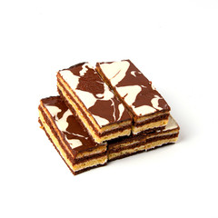Milk and chocolate rectangular pieces of cake isolated on white background