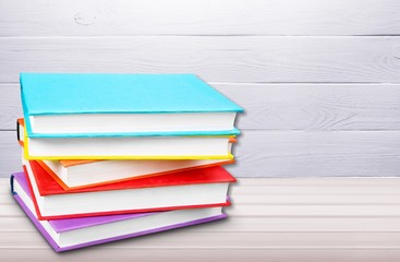 Colorful books collection on background.