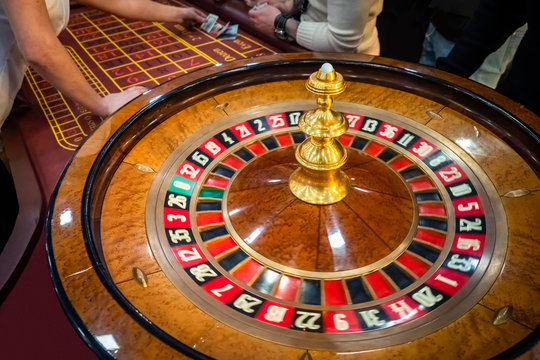 Roulette. The game in the casino. The concept of expectation of good luck. Hands of a man next to the playing table. Luck. Fortune. In search of good luck. Roulette runner close up. Winnings. Betting