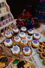 Candy bar wedding cake decorated by flowers standing of festive table