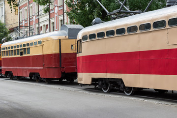 Red retro trams on a city road