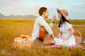 Man playing guitar on a picnic. young man playing guitar in park on a sunny day.