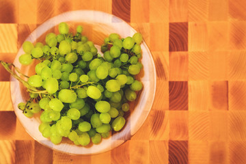 Green grape on the wooden cutting board