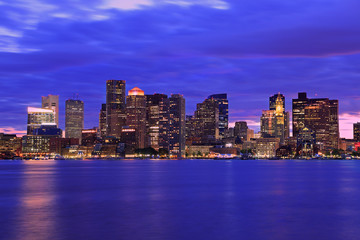 Fototapeta na wymiar Boston skyline at dusk with skyscrapers reflection on the ocean, Massachusetts, USA