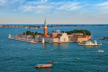 Fototapeta na wymiar Aerial view of Venice lagoon with boats and San Giorgio di Maggiore church. Venice, Italy