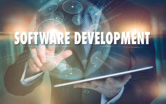 A hand selecting a Software Development business concept on a futuristic computer display.