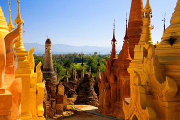 SHWE INDEIN PAGODA, MYANMAR - DECEMBER 23. 2015: View beyond old stone pagodas over green valley on...