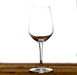 Emty wine glass on wood table. Isolate on white background.