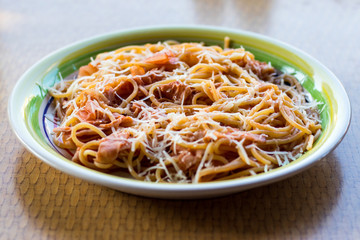 Spaghetti with bacon, balyk, chicken, tomato sauce, onions and parmesan
