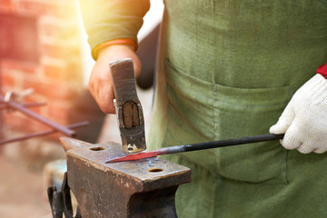 Closeup of a blacksmith working with a hammer