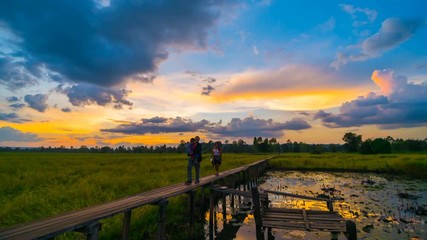 time lapse of 100 year-old wooden bridge with sunset at Khonburi, Nakhon Ratchasima, Thailand