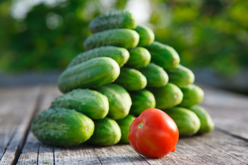 cucumbers and tomato on the wooden table