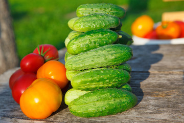 cucumbers and tomatoes on the wooden table