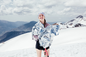 Positive young girl tracker enjoys her journey and active tourism in mountains on cold winter christmas day. The concept of generation Y and Z and a healthy lifestyle. New year holidays, strong woman