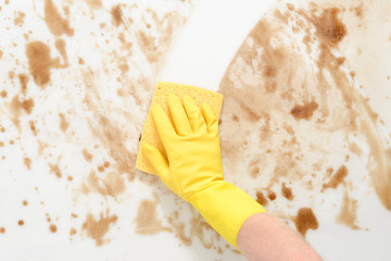 Gloved Hand WIping a Dirty Counter or Floor with Sponge